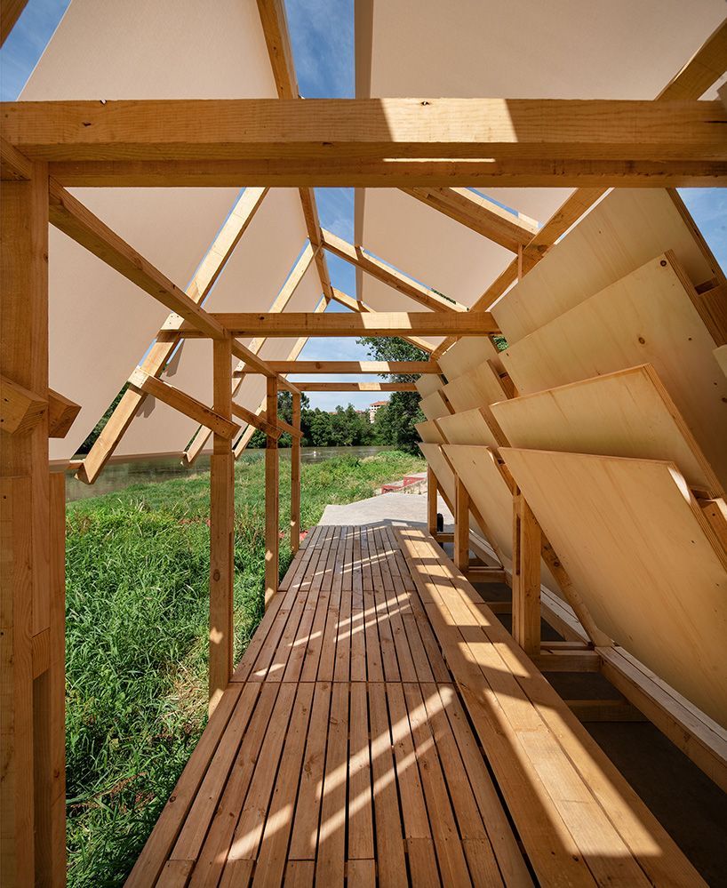 shaded wooden pavilion by erazo pugliese reclaims neglected dock along river in spain designboom.com/architecture/s…
