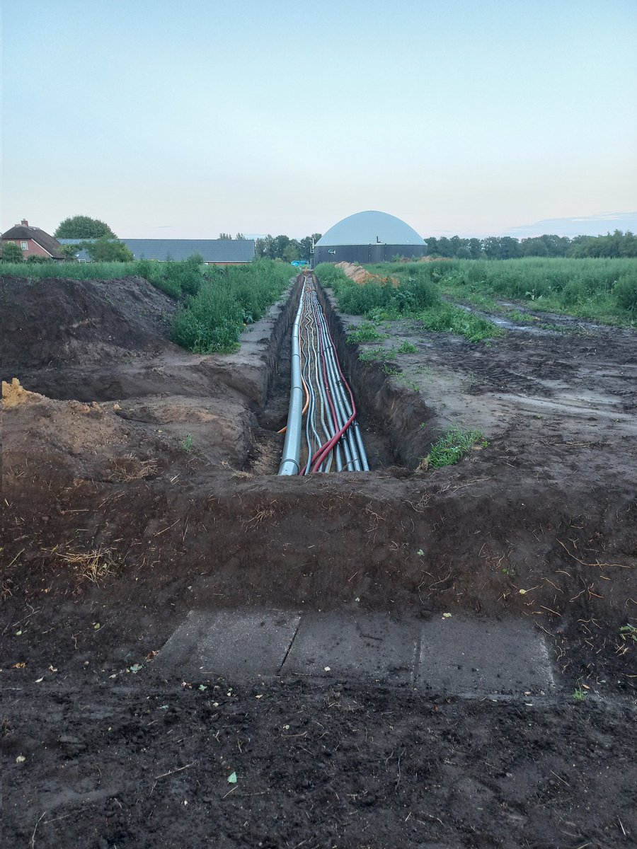 Een varkenshouder bouwt een biogasinstallatie aan de overkant van de straat. Daar gaat nogal wat leidingwerk de grond in.