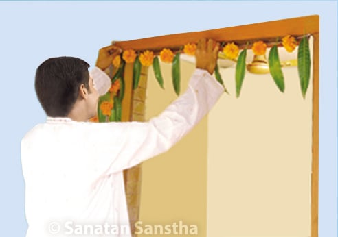 Decoration with toran (a bunting of mango leaves and red flowers)

Toran

After a bath we should decorate the lintel of every door with a toran. Red flowers are used because red colour symbolizes auspiciousness.

More 👇sanatan.org/en/a/166.html