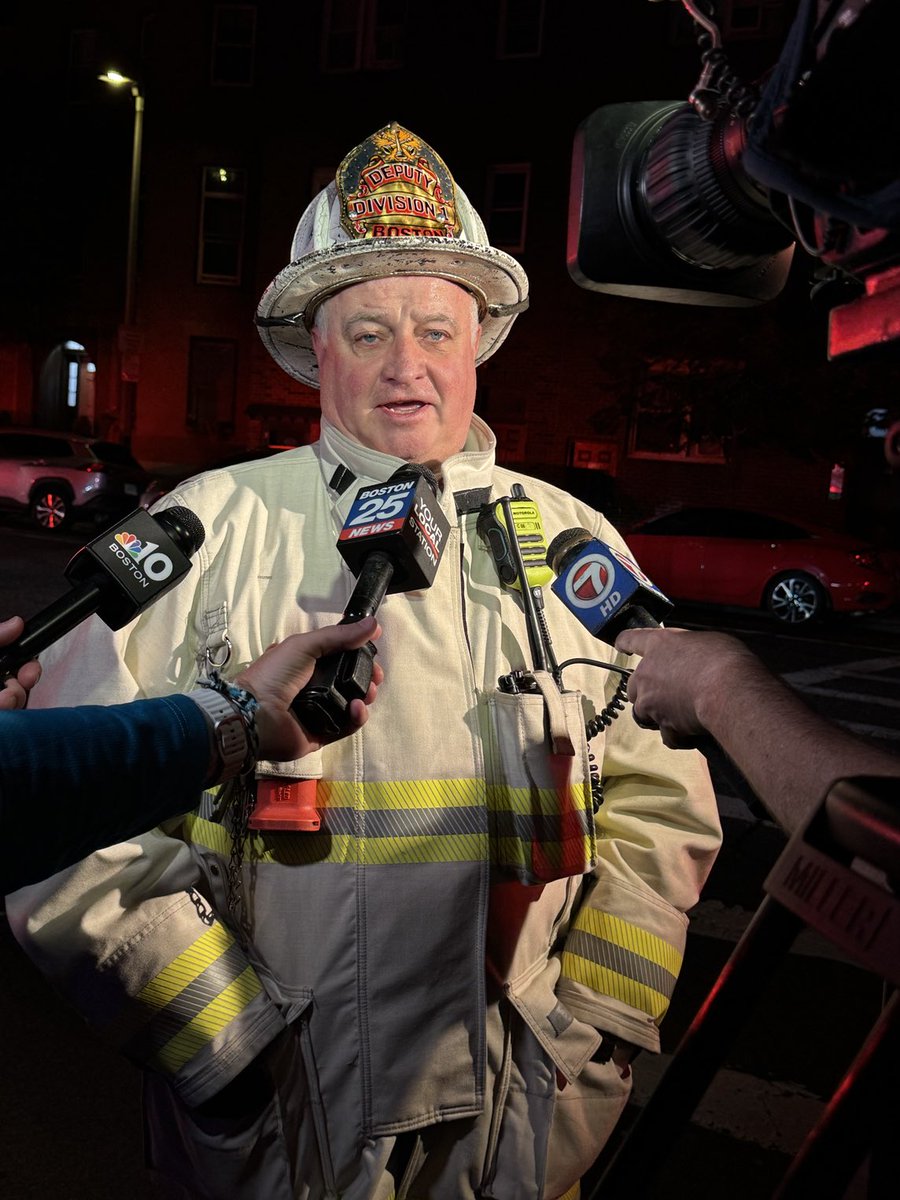 BostonFire's tweet photo. Deputy Chief Martin McCormack briefs the media on the Tech Rescue on Chelsea &amp; Emmons st E. Boston. Rescue 1 had to pull the truck out of the building &amp; Firefighters had to shore up for safety. 4 residents are displaced but not injured.Engineers will determine the damages. https://t.co/tbRPVQ8aUN