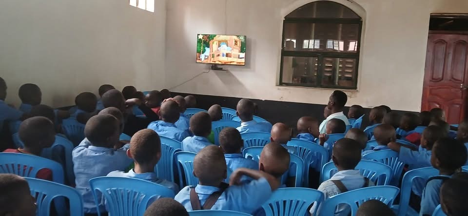 Once a satellite TV set was installed in the Uphill school hall, all the children gathered to watch, many for the very first time. It's a fun way for youngsters hear and pick up English - still the national education and administrative language in Uganda.