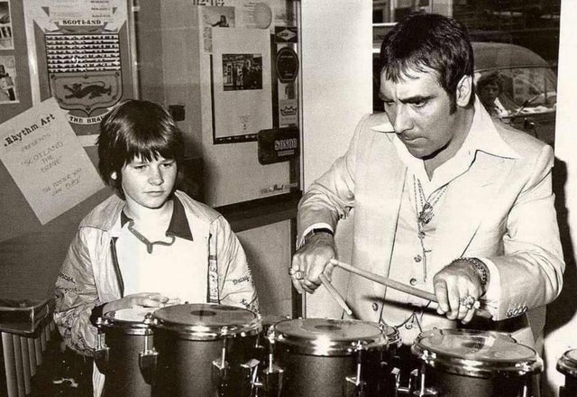 Zak Starkey (Ringo Starr's son) watches Keith Moon playing on the drum kit that Keith bought for Zak's birthday.