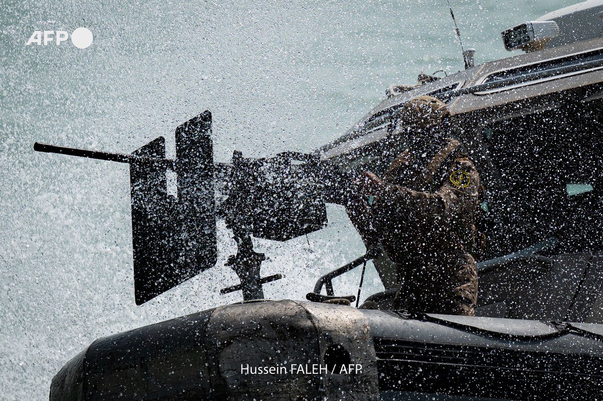 An Iraqi navy marine has a sip of water from a bottle while aboard a vessel at sea in the Gulf south of the Faw peninsula on August 5, 2025.
Hussein FALEH / AFP