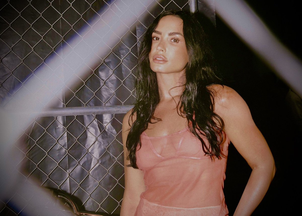 “Before Brat was even a concept, Lovato was already embodying a chaotic girl archetype that bridged scene queen, club kid, and ‘Hot Topic if it made bangers.’ She wasn’t just performing at Jingle Ball — she was in the club after, making out with a bottle of Sobieski and dancing