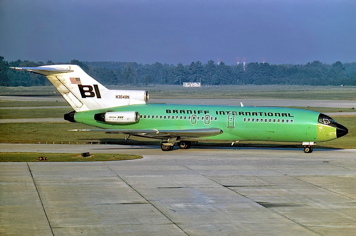 FLY THE BRANIFF ROCKET HOUSTON DALLAS EVERY HOUR ON THE HOUR - Braniff International Boeing 727-116 registered as N304BN is taxiing at Houston Intercontinental Airport, Texas, in October 1969. Braniff's jetliner is painted in the 1967 Alexander Girard/Harper and George Light Lime
