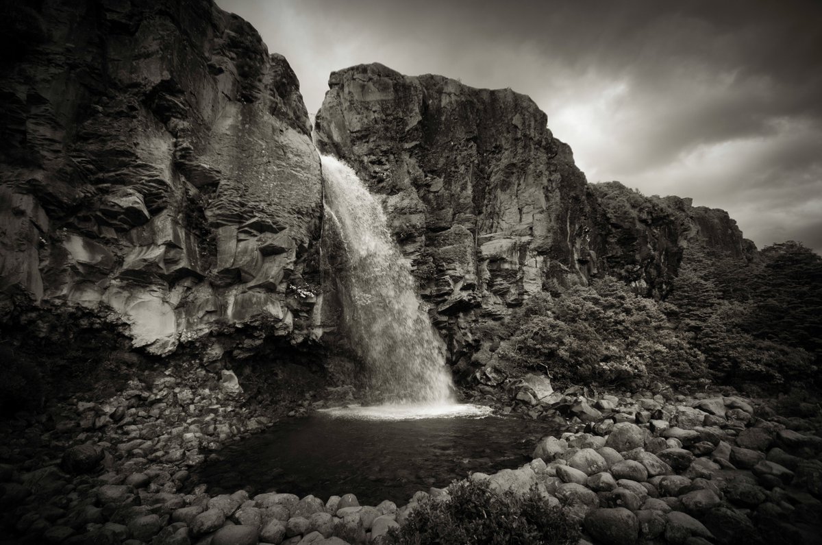 Taranaki Falls, New Zealand. Shot near Whakapapa, this dramatic cascade flows through volcanic rock and Middle-earth myth.

Featured in The Hobbit, this place is all mist, magic, and mana.

Own a piece of cinematic #Aotearoa. <a href="/opensea/">OpenSea</a>
