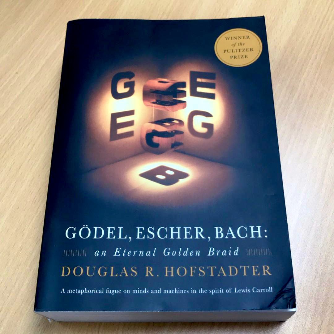 ‘Gödel, Escher, Bach’ by Douglas Hofstadter, a 1979 book exploring common themes in the lives and works of logician Kurt Gödel, artist M. C. Escher, and composer Johann Sebastian Bach, the book expounds concepts fundamental to math, symmetry, and intelligence.