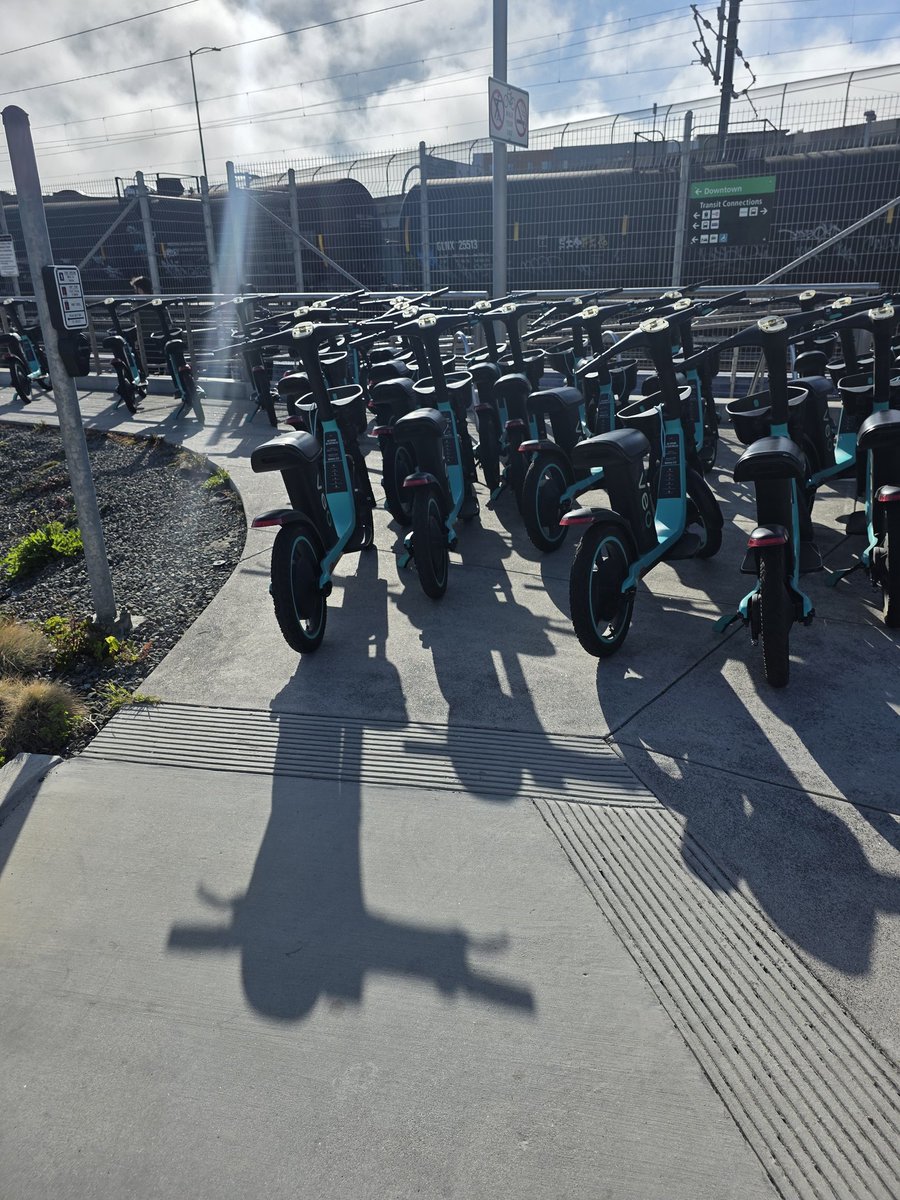 mhilljackson's tweet photo. @VeoMobility there's way too many of these bikes at South SF station. You can't even walk on the sidewalk. WTF https://t.co/ZxQrXXBetz