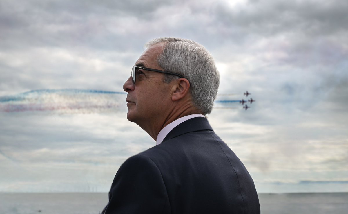 Nigel Farage refuses to watch the Red Arrows fly past as it would mean we couldn't see his face on this carefully staged photo of him pretending to watch the Red Arrows fly past.