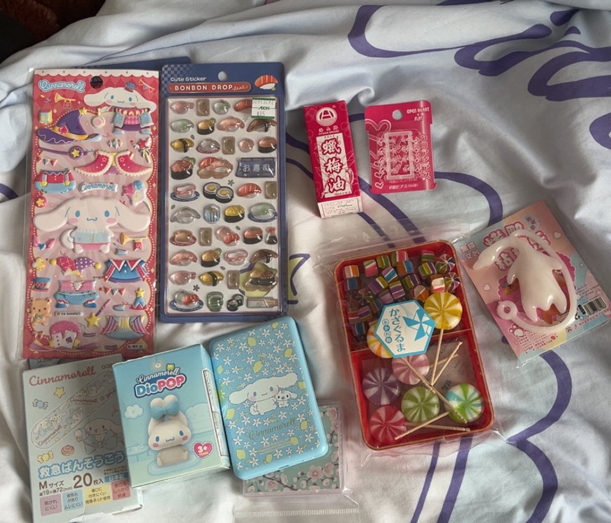 MORE STUFF!! stickers, bandaids, blind box, power bank, ointment for my inflamed ear lobe, candy and that weird goose toy is from my 6 year old cousin 😭