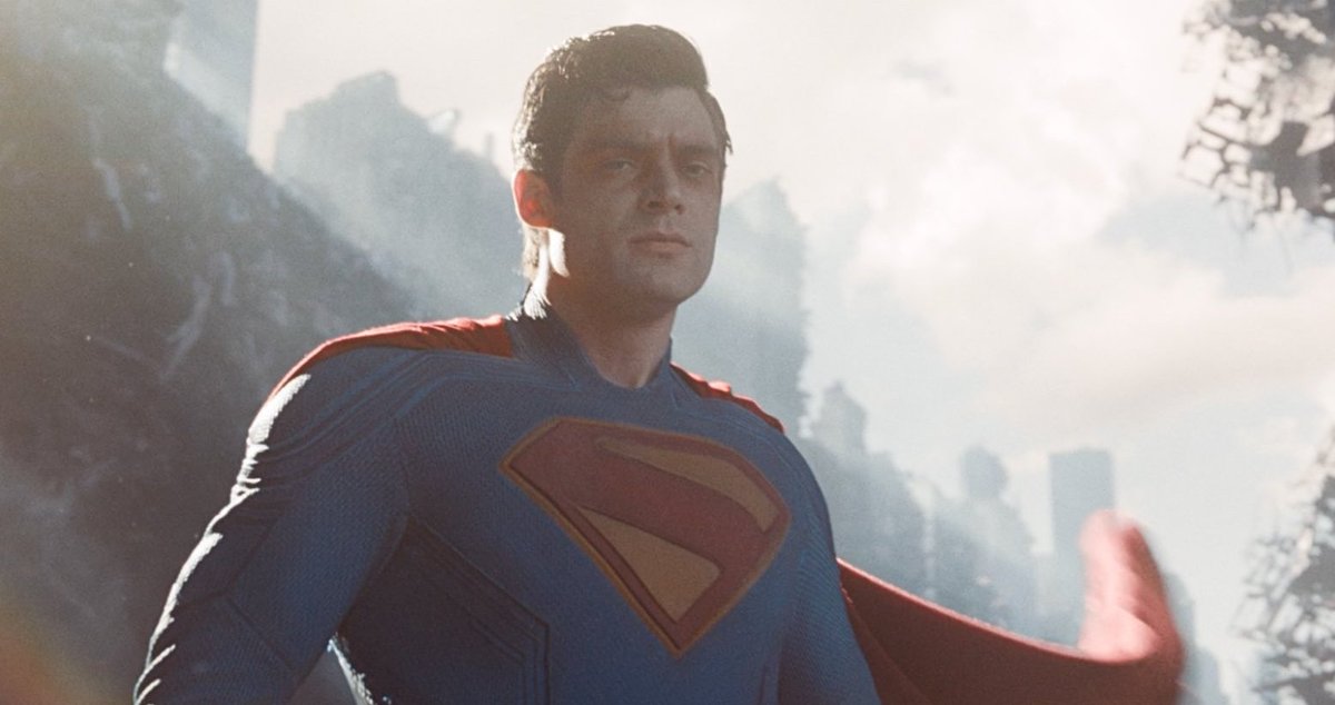 Christopher Nolan dressed as Superman finding out that Denis Villeneuve is doing the next James Bond.