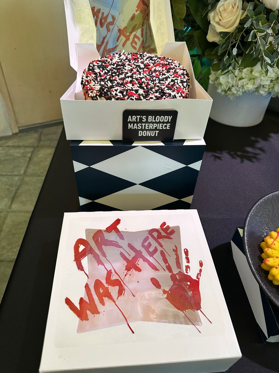 insideuniversal's tweet photo. Some of the food &amp; drink inspired by Terrifier and Art the Clown, including Sunflower Glasses Cookies and Art’s Bloody Masterpiece Donut. @HorrorNights #UniversalHHN https://t.co/AUK3ztFSYD
