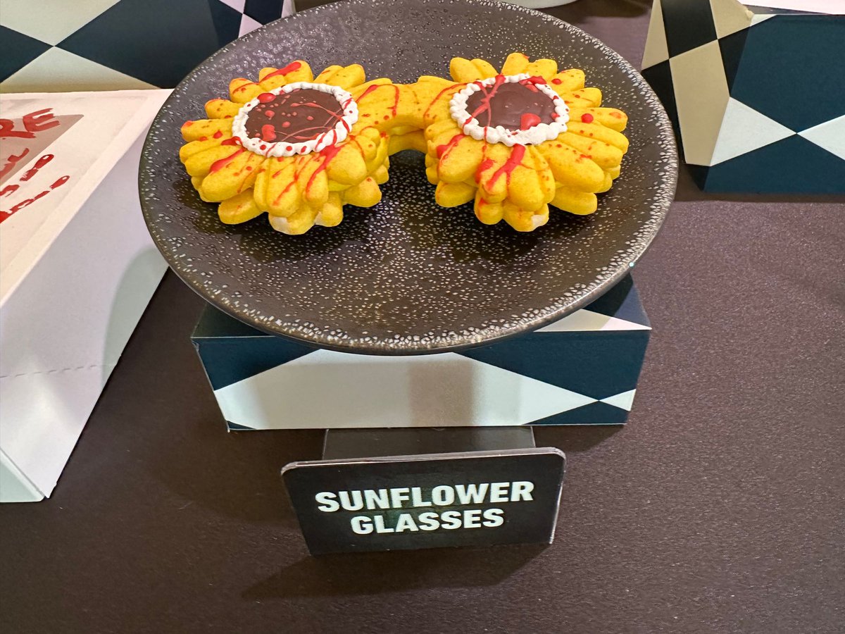 insideuniversal's tweet photo. Some of the food &amp; drink inspired by Terrifier and Art the Clown, including Sunflower Glasses Cookies and Art’s Bloody Masterpiece Donut. @HorrorNights #UniversalHHN https://t.co/AUK3ztFSYD