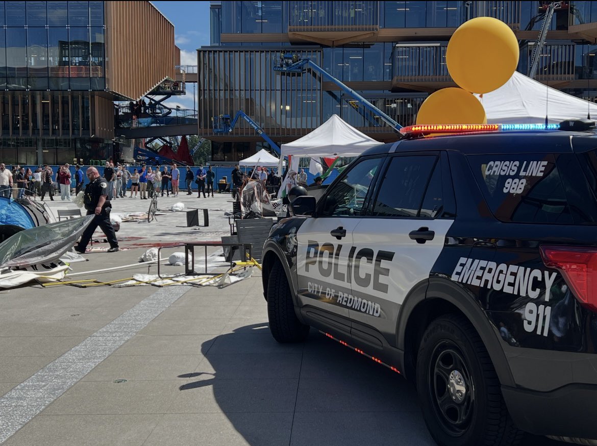 RedmondWaPD's tweet photo. 18 arrested for various charges during a protest at Microsoft Campus

Redmond police are at the scene of a demonstration at the Microsoft campus. On Aug 20, around 12:15 p.m., Redmond officers were dispatched to a large gathering of protestors in the Microsoft courtyard. 

Officers initially attempted to trespass the protestors, but they resisted and became aggressive. 

A few protesters had poured paint over the Microsoft sign and on the ground. 

Others had blocked a pedestrian bridge and were using stolen tables and chairs from vendors to form a barrier. 

Officers took 18 into custody for multiple charges, including trespassing, malicious mischief, resisting arrest, and obstruction. No injuries were reported. 

Thank you to Washington State Patrol, Bellevue, WA Police Department, and Kirkland Police Department for assisting during the incident. This is an ongoing investigation.