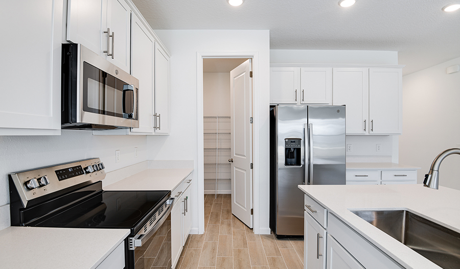 RAHomes's tweet photo. This move-in ready home is available in Mascotte, FL! Well-appointed kitchen offering 42" cabinets, quartz countertops, a large island & a walk-in pantry | Versatile loft | Serene covered patio #HotHomes https://t.co/c1L71Cu0Rh https://t.co/8dypev1ulW