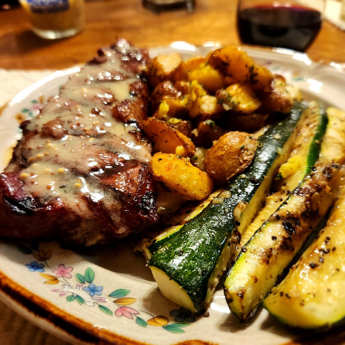 Strip w/Dijon pepper sauce, grilled herbed potatoes, and zucchini spears fresh from the garden.