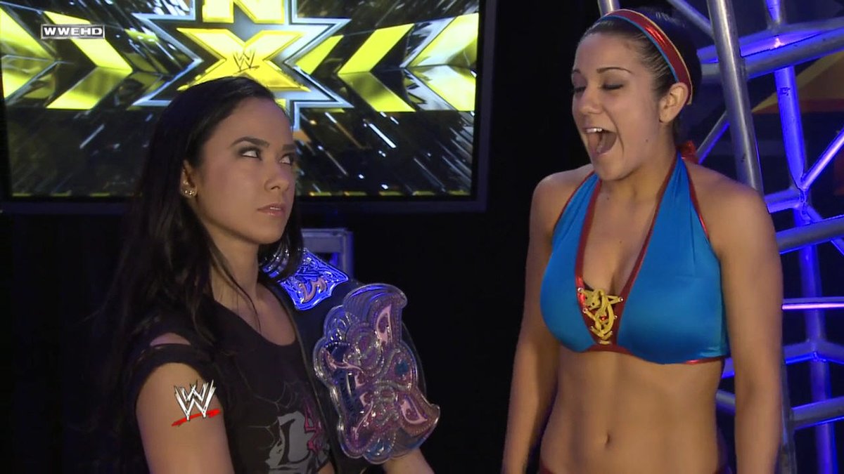 TravisJonesWWE's tweet photo. Lady @TheAJMendez - The #WorldWrestlingEntertainment #DivasChampion is giving @itsBayleyWWE the I want to take her down with the #ShinningWizard look & the frightening thing is that she can, #TeamAJ. #RT if u agree #WeLoveAJ #IconicAJ #AJFansForEver #WWENXT #WWERAW @WWE @WWENXT https://t.co/pvRbheHtb9