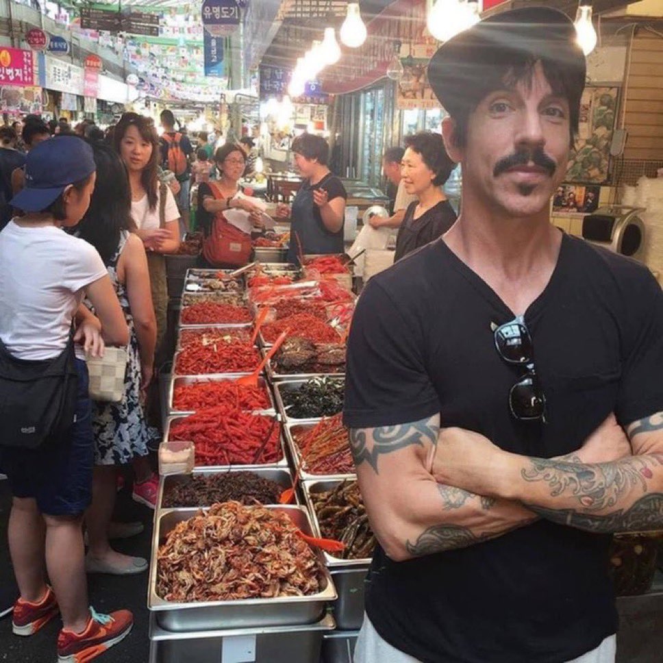 A Red Hot Chili Pepper posing with more Red Hot Chili Peppers