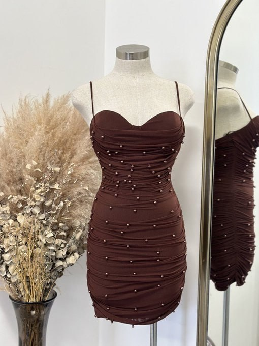 Stylish brown dress with pearl embellishments, elegantly displayed with dried pampas grass.