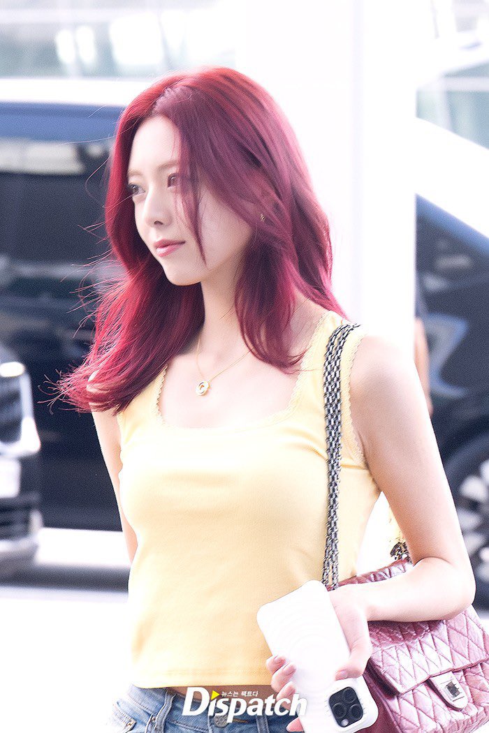 ITZY's Yuna shows off her new fiery red hair color at the airport.