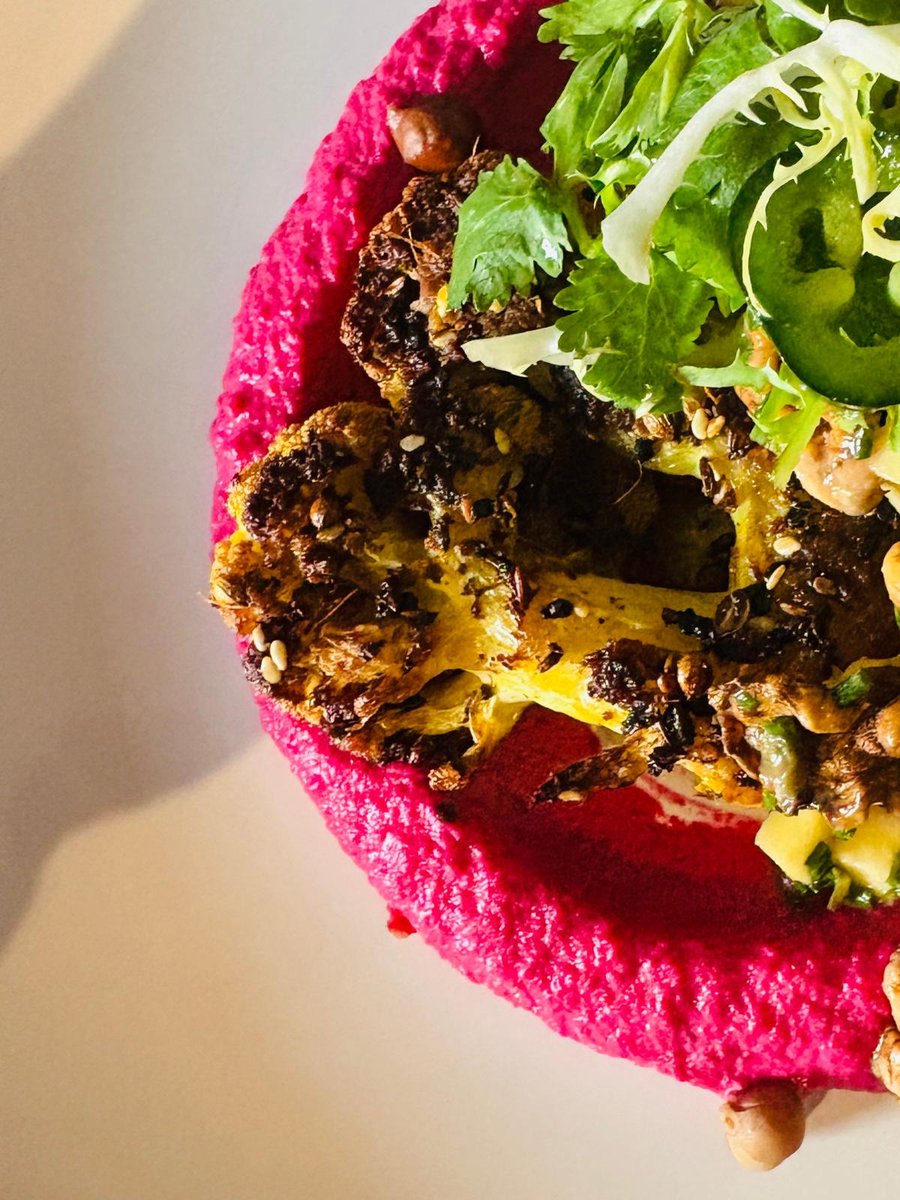Roast spiced cauliflower, beetroot hummus, pickled walnut &amp; apple salsa, coriander and jalapeño — a show stopping starter with incredible colours! 

#VibrantEats #SummerSalads #FreshNotBoring #FlawlessFood #StrawberryShortcakeDining #WelshWeddingCaterers #WeddingCaterers #Vegan