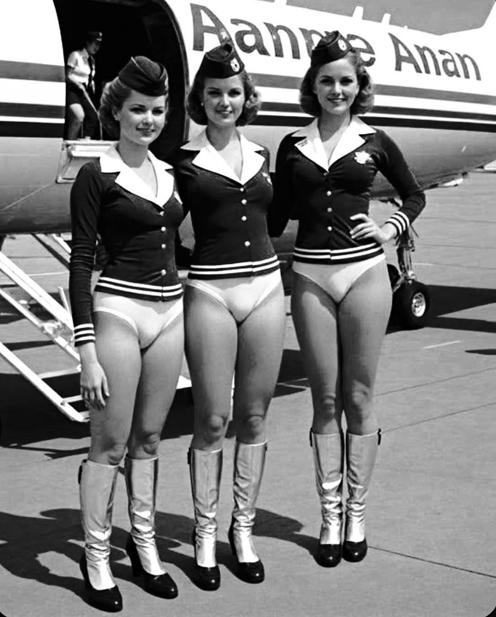 I sometimes get the most wonderful pictures cropping up in my social media feed. This AI generated, supposedly historical air hostess outfit, for one. If only! Although I do frequently enjoy the very smart, often navy blue, form-fitting uniform skirts the lovely real girls wear.
