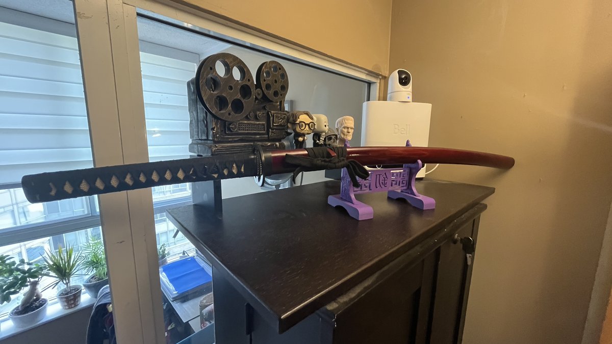 sinistervibe's tweet photo. 3d printed a stand for my katana today.  I ran out of black filament so I had use purple. https://t.co/hZvWcr8gAv