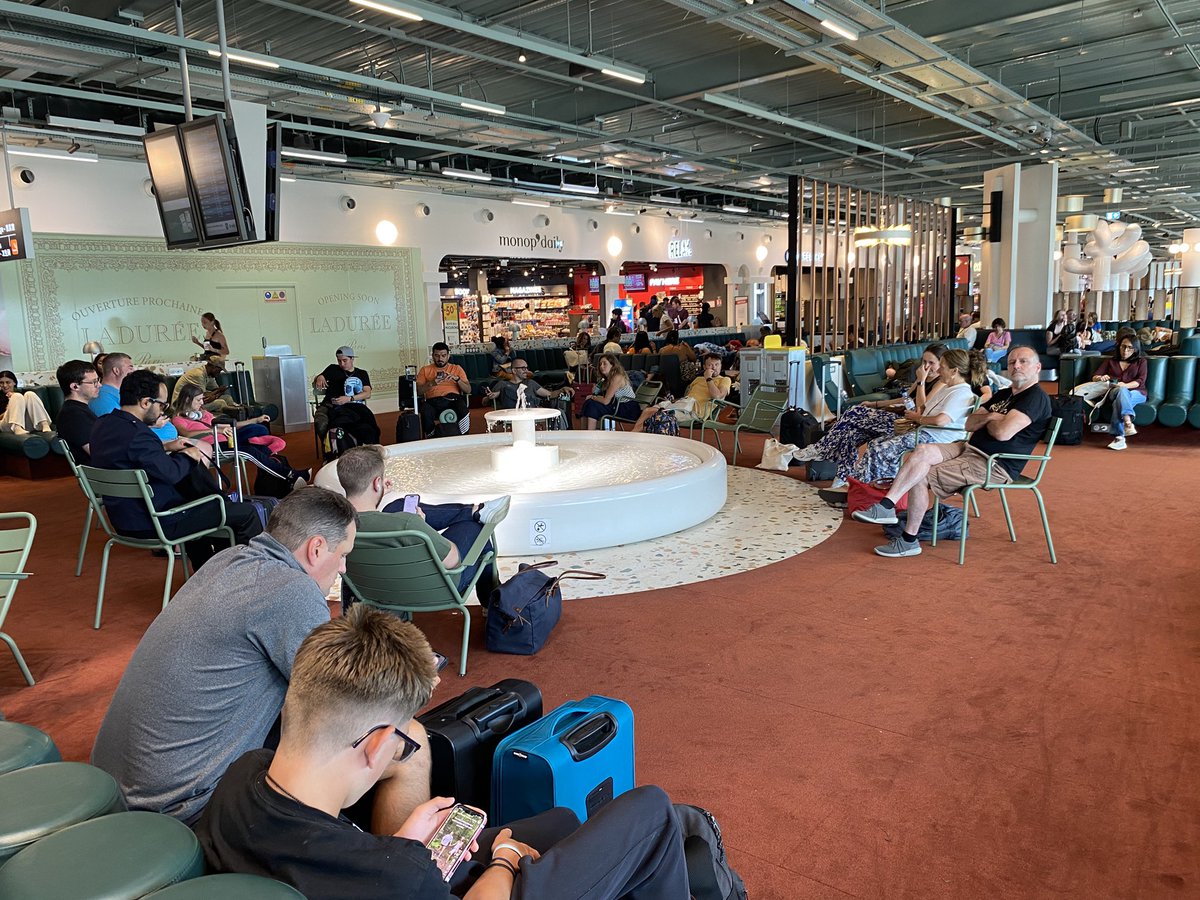 Water fountain attracts people, even inside a airport
