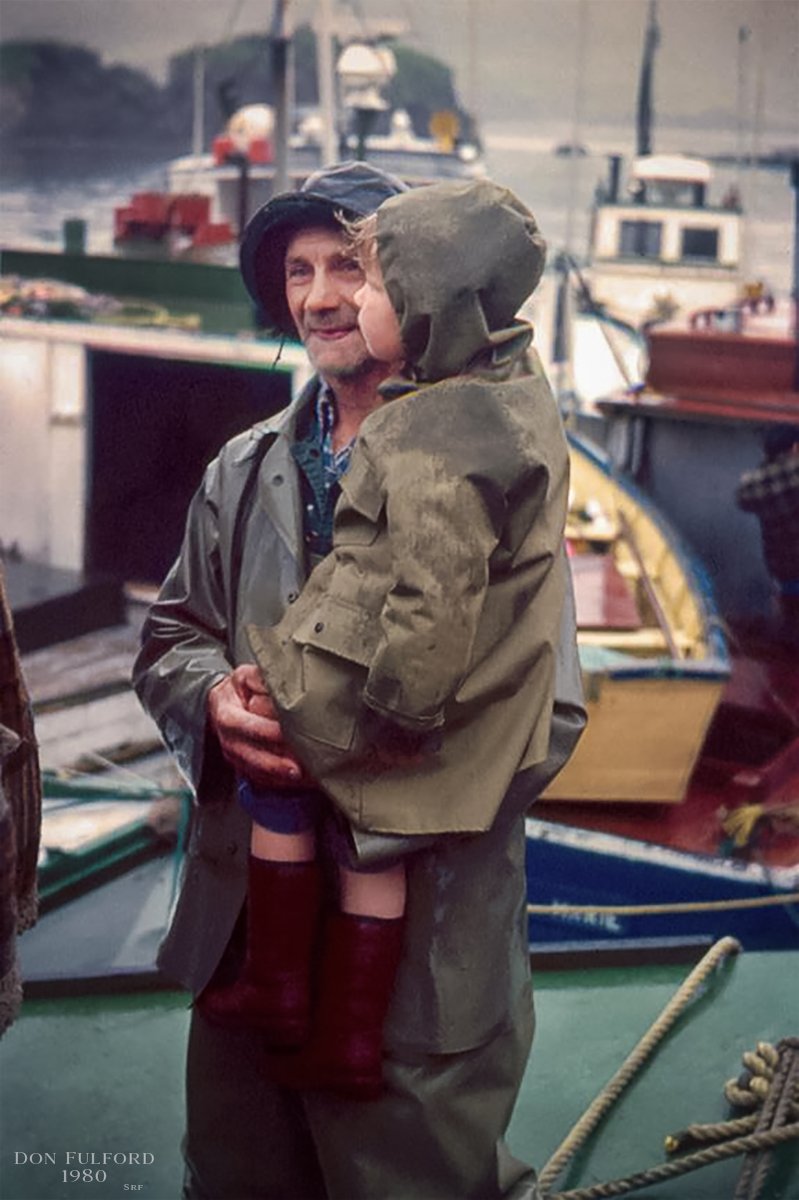 Here's a photo Dad took at the Merasheen Reunion in 1980. I always thought this was an awesome photo! I scanned in the original slide and did a bit of work on it in PhotoShop. The gentleman's name is Leo Pomeroy I believe, the child I don't know. It's a classic photo imo. 🙂