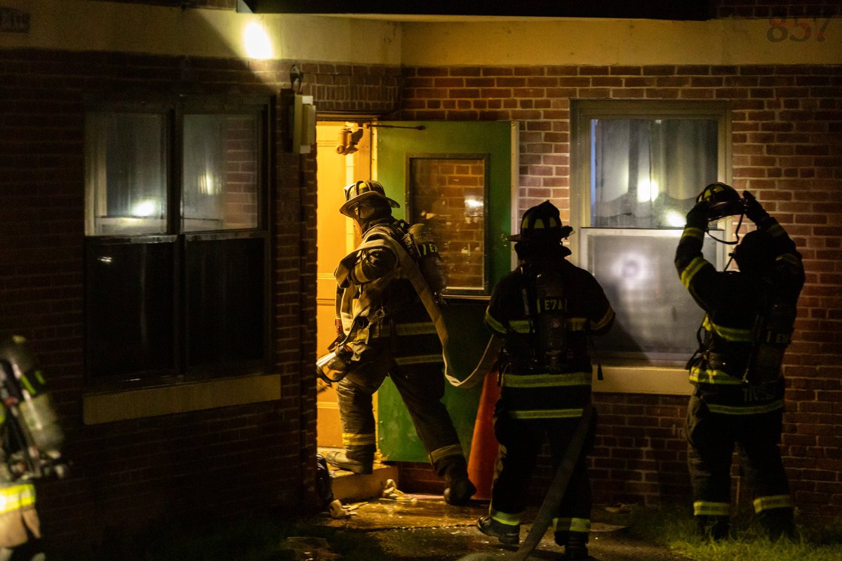 Somerville Firefighters work to battle a 2 alarm fire that consumed a second floor apartment in a 3 story public housing building on Powder House Blvd, late Sunday night.