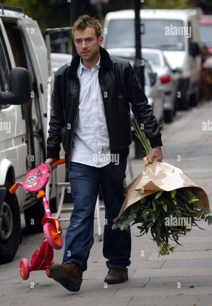 damon carrying missy’s tricycle that has a noodle sticker on it