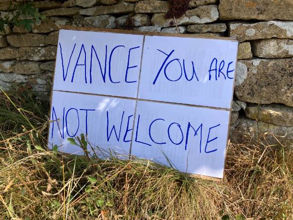 OxfordClarion's tweet photo. Residents of Dean have erected placards protesting against the arrival of American vice-president J.D. Vance in the tiny West Oxfordshire village. They say they are “extremely angry” but the police presence which has sealed off the village has made a “proper protest” impossible. https://t.co/o028Ls6osV