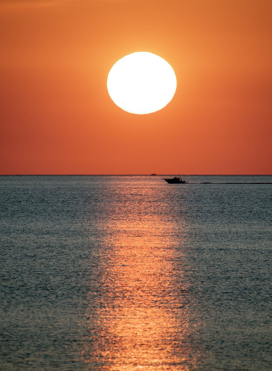 Just another beautiful summer morning along the Lake Ontario shoreline in Greece. As the sun was rising there were numerous charter fishing boats along the horizon heading out for the day, hoping to land some trophy size trout and salmon.