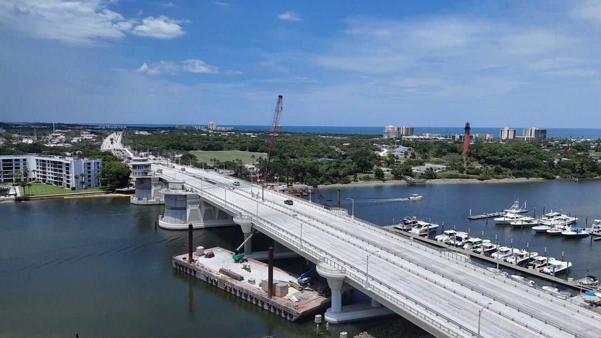 America250FL's tweet photo. In Jupiter, FL, traffic in both directions is now flowing on the new U.S. 1 Jupiter Bridge. This comes just in time to celebrate America’s 250th Anniversary!🎆🥳

The historical Jupiter Lighthouse and WWII-era naval barracks can be seen in the background. Throughout our history, America has been known for building great infrastructure, and this is no exception. We proudly celebrate our history and continue that legacy here in the Free State of Florida. 🌴🎉

#America250FL