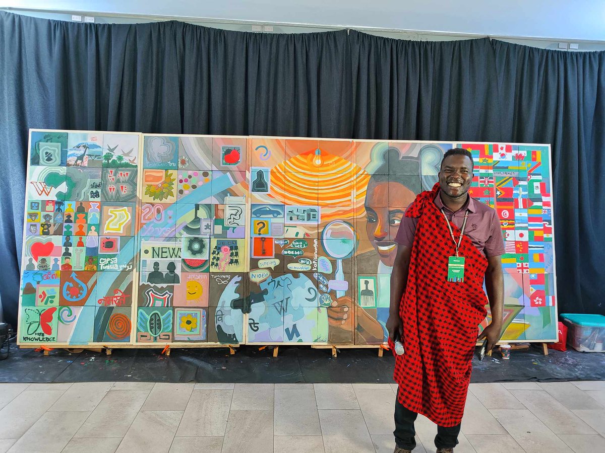 RonaldLomo's tweet photo. They said “leave your mark at Wikimania,” so we grabbed brushes. 🎨
Now we have a mural that’s basically Wikipedia… but with more colors and fewer edit wars. 😉

#Wikimania #PaintedByTheWorld #KnowledgeForAll https://t.co/Ul8DMQvrex