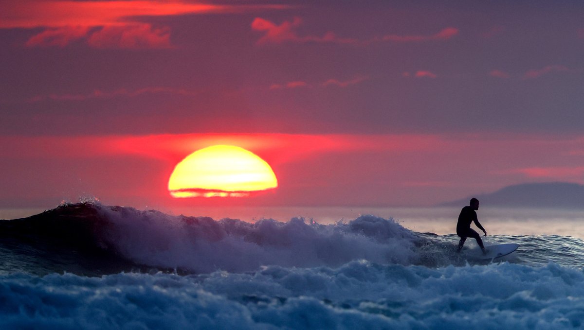 Surfing at sunset at Tullan Strand, Donegal