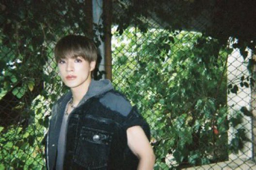 In denim draped   like   shadows'   skin,  He
walks     where     silence    used     to    sing—
Through rusted trains and blooming green
A ghost of youth, forever seen.
