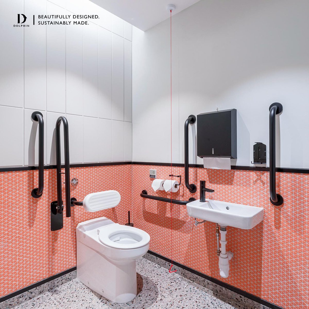 This accessible washroom makes a statement with its distinctive pairing of rich coral tiles at the base, transitioning to fresh white above.

The sleek black accessible fittings pull the whole look together, creating a cohesive finish.

🔗 eu1.hubs.ly/H0mh2dm0