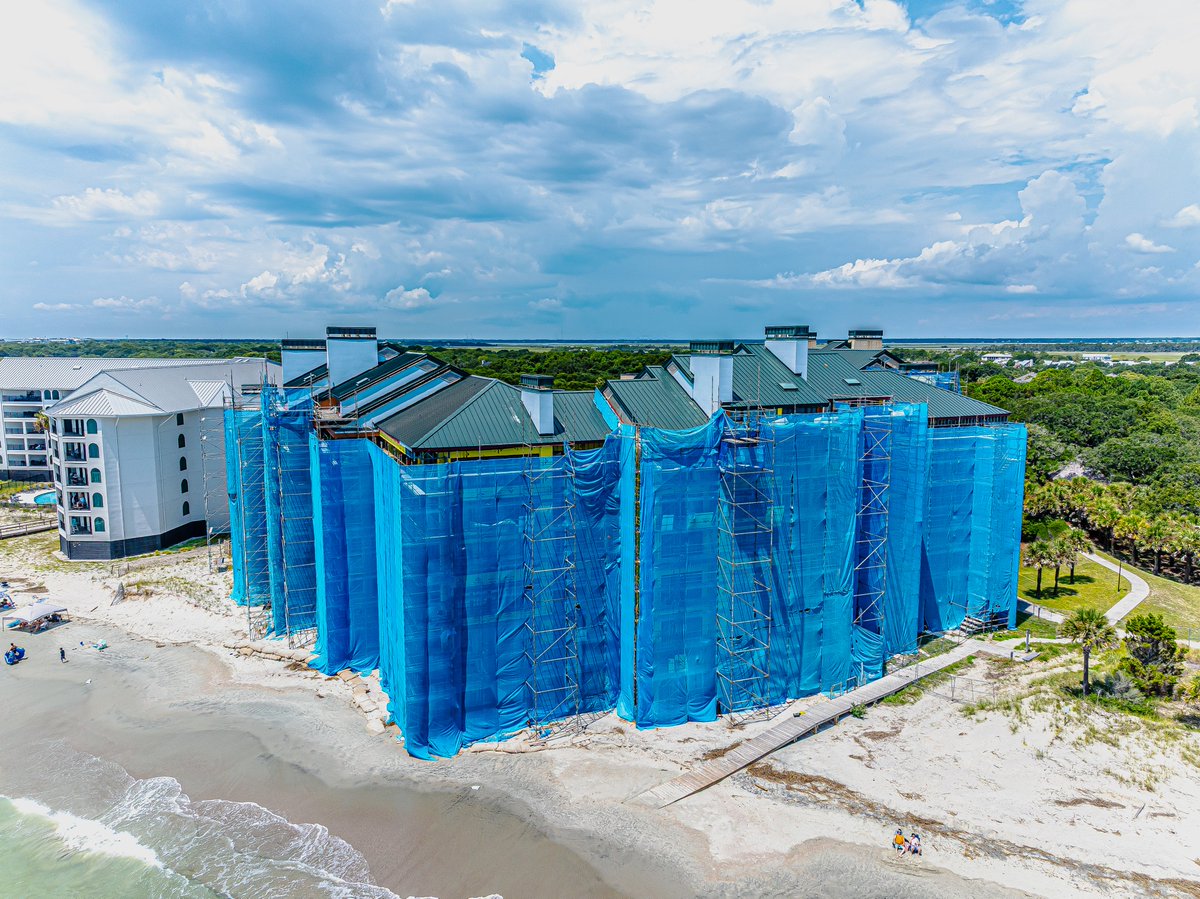 HillCon's tweet photo. Construction with a view! Progress is well underway on Buildings 1 &amp; 4 at the Ocean Club in Wild Dunes on the Isle of Palms. The project scope includes replacing exterior walls, roofs, &amp; windows, along with balcony repairs to enhance both durability &amp; aesthetics. https://t.co/hIrp3laAau