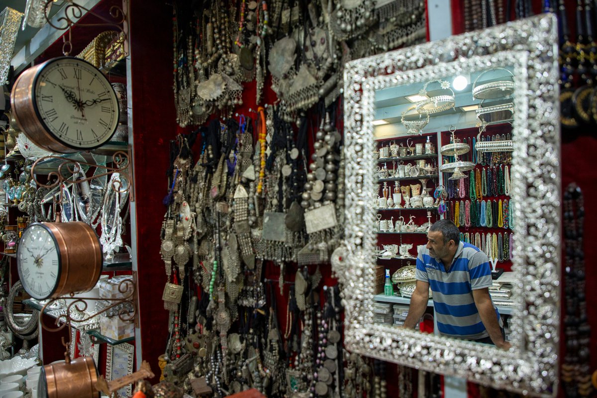 faisalbashirs's tweet image. A shopkeeper is seen reflected in a mirror as he waits for customers at a jewelry shop in Srinagar. August 2025. Photo by @faisalbashirs