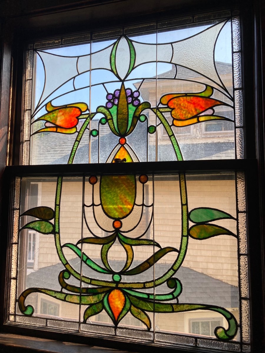 An unusually strong Art Nouveau influence in the design of this window in Boston Massachusetts. Most are more Victorian without these swooping lines. There are a variety of colors in the green leaves and scrolls, possibly it’s a repair or maybe it was part of the original design.