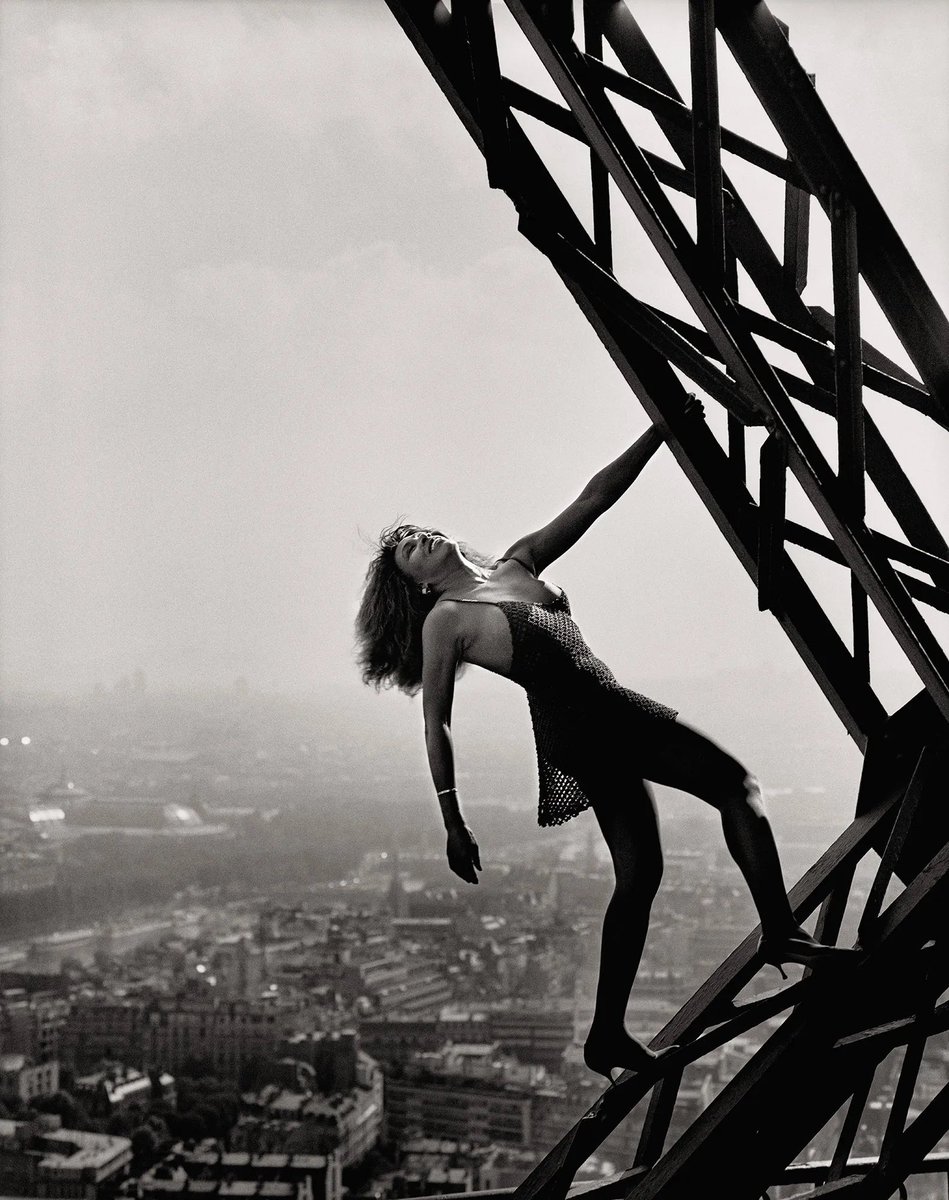 Tina Turner hanging off the Eiffel Tower.