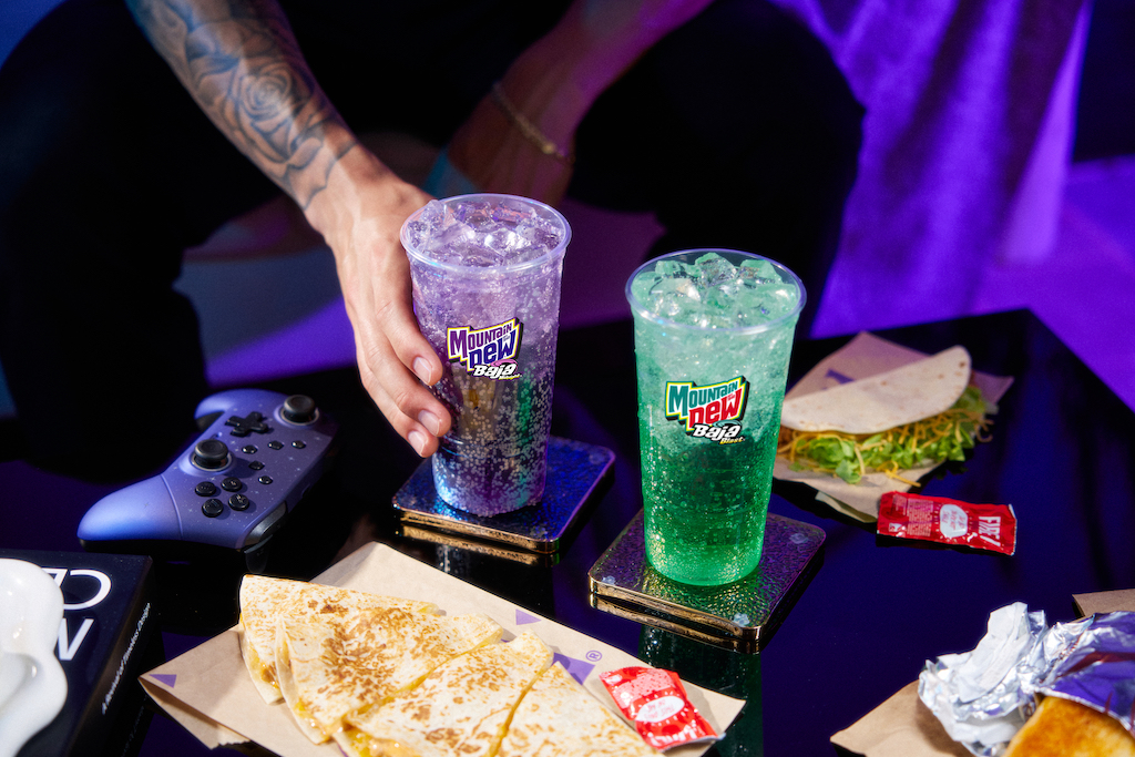 Taco Bell Debuts A New Mountain Dew Baja Blast Midnight Flavor 😮

Baja Blast is getting a sibling. After two decades of cult status, Taco Bell is expanding its most iconic drink with a new permanent flavor—Mountain Dew Baja Midnight—hitting menus nationwide on August 14.