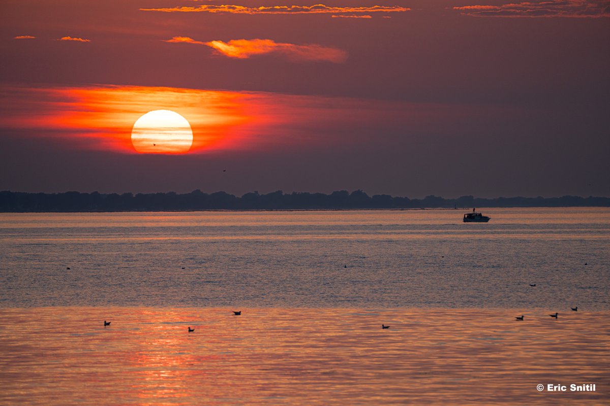 The Sun sets on the final day of our heat wave. Captured over Lake Ontario from north of Rochester, New York.