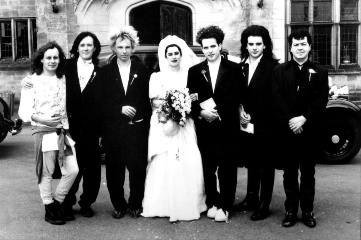 Happy Anniversary to #RobertSmith &amp; Mary Poole!

The group photographed with Robert Smith and Mary Poole by Tom Sheehan at the wedding celebrated at Benedictine monastery in Worth Abbey, Sussex, England. August 13th 1988.