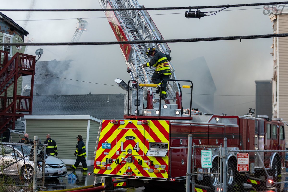 Firefighters use master streams to battle a 5 alarm blaze that tore through 5 Lowell St buildings in Lawrence yesterday evening.