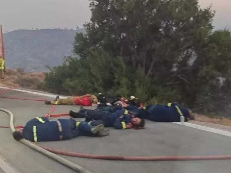 daphnetoli's tweet image. In an image making the online rounds today in #Greece, firefighters exhausted and flat on the ground are captured taking a brief rest after hours battling the raging wildfire in #Chios. A stark image of the grueling battle against the flames.