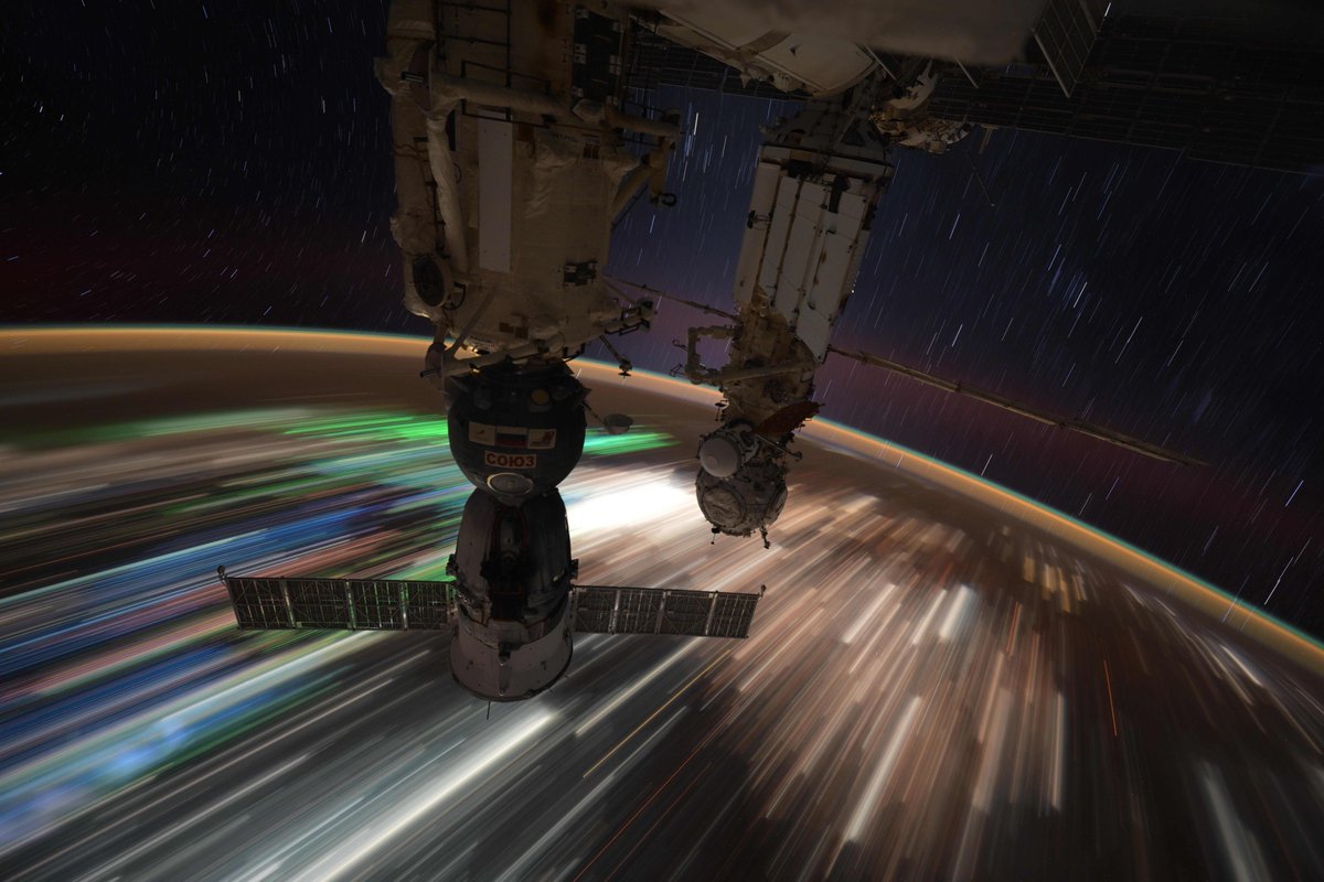 Space station streaking across the multicolored nighttime lights of Southeast Asia.