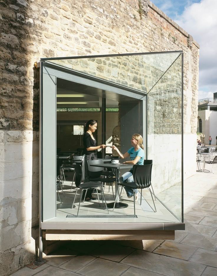 A contemporary glass extension integrated with an older stone building at Oxford Castle