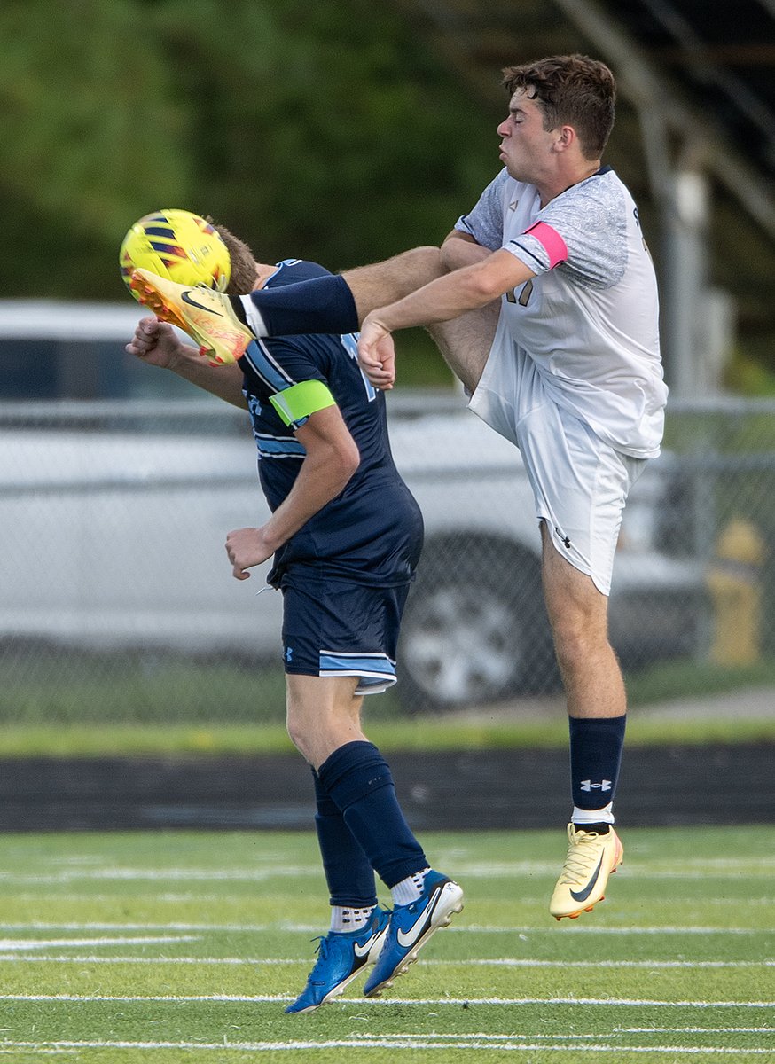 South Brunswick defender Collin Peattie heads the soccer ball as a North Brunswick player tries to kick it. South, down a player in the final 19 minutes, beat North 2-0 in the game Aug. 13, 2025.